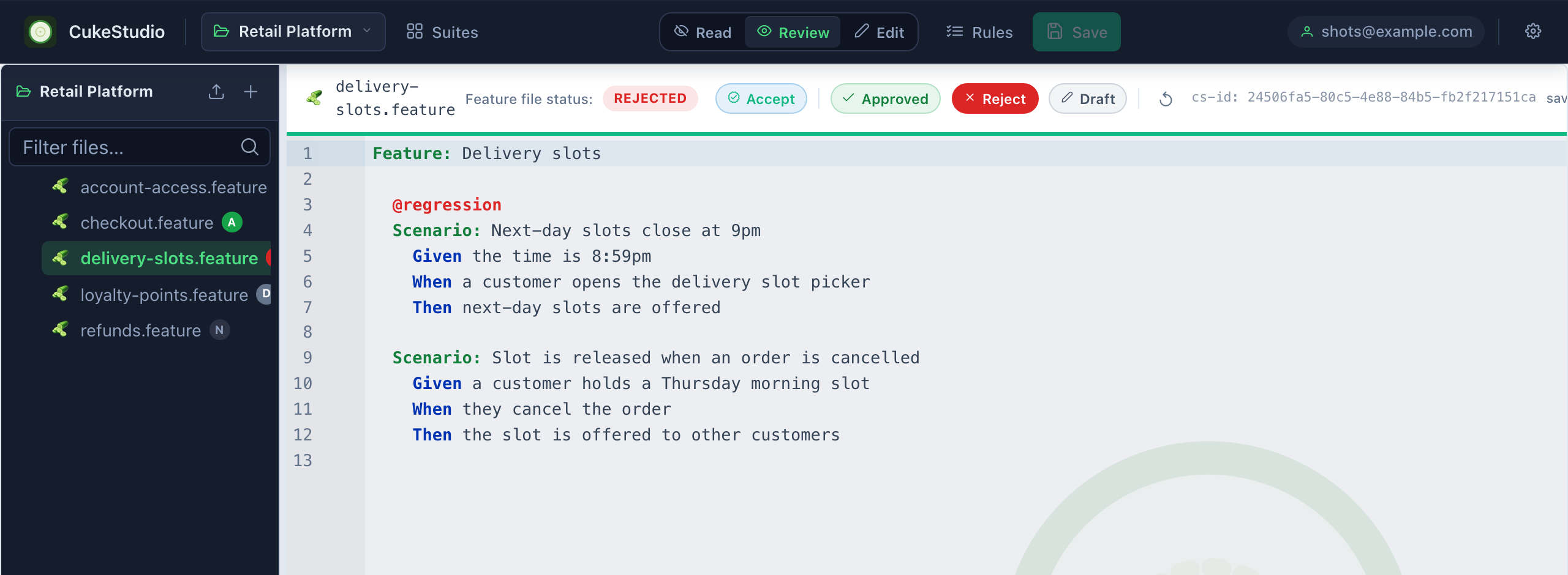 The CukesStudio editor showing a feature file in review mode, with review controls and the file's review state in the header.